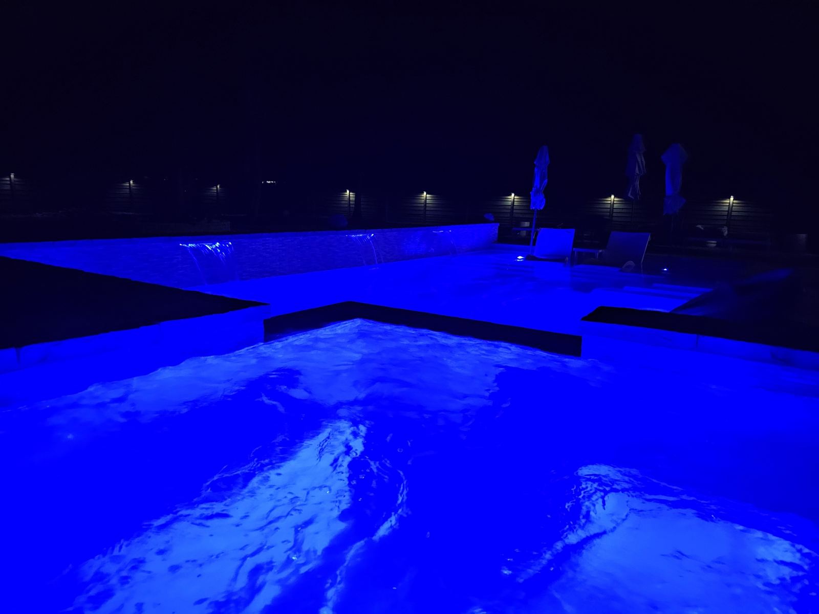 Pool lit magenta and blue at night